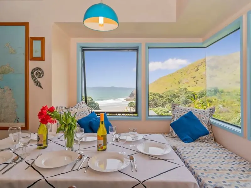 Dining nook with window seats and views of the beach and hills